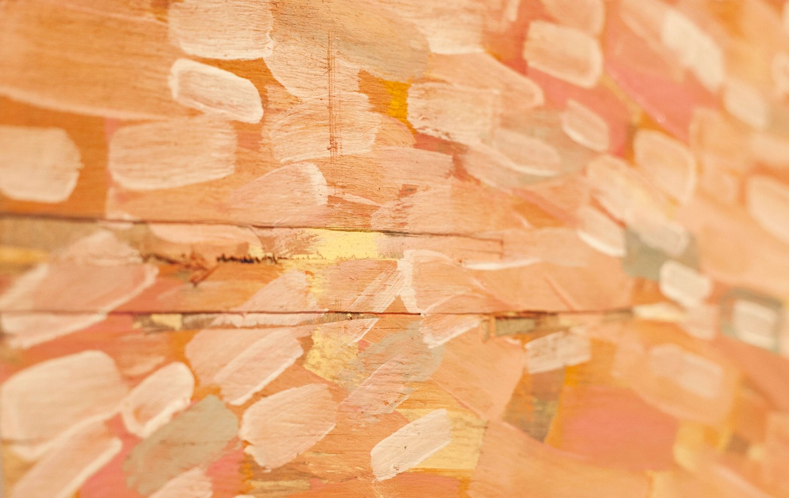 Close-up of a warm-toned abstract canvas covered in short stacked horizontal paint dabs, by Osmar