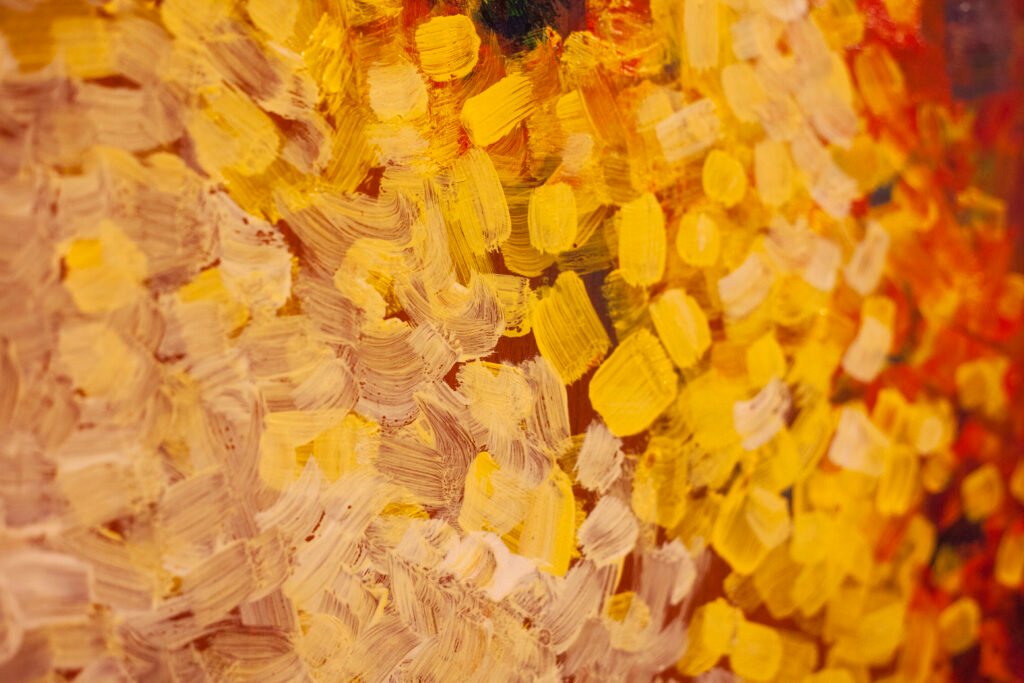 Close-up of an abstract pointillist canvas with thousands of tiny yellow, orange, and white paint dots, by Osmar