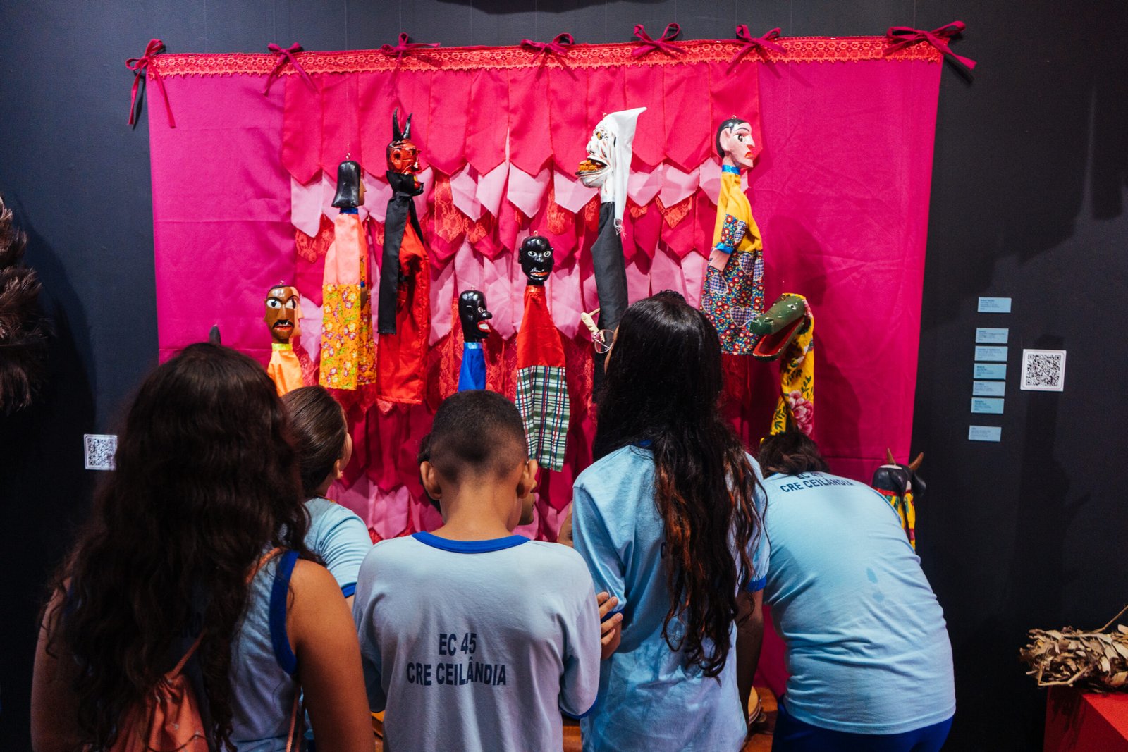 Photograph capturing an indoor stage event or performance illuminated by bright red lighting, by Osmar